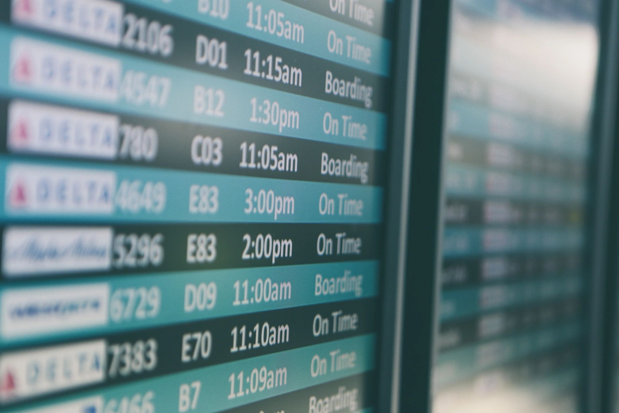airline departures board showing multiple flight departure times