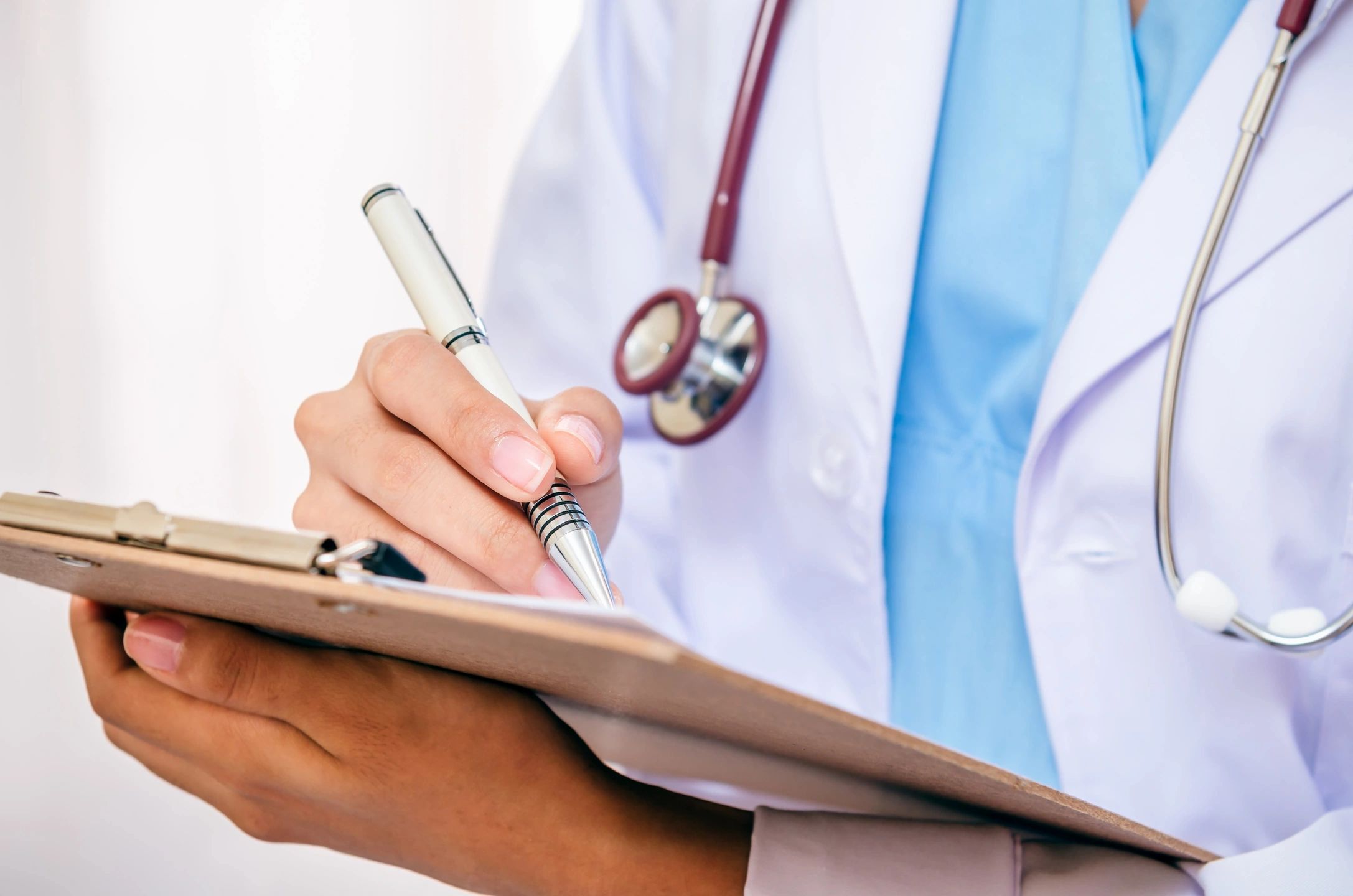 doctor writing on a clipboard