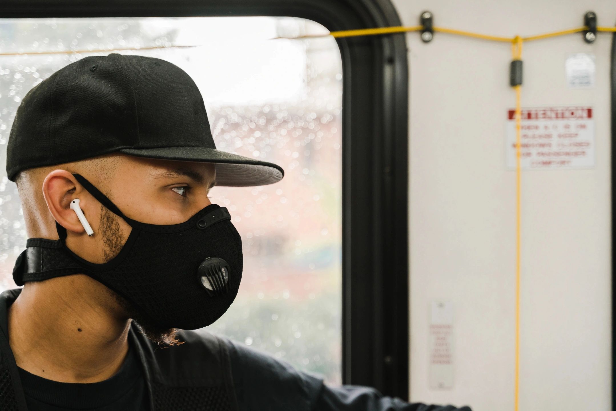 man wearing face mask on public transit